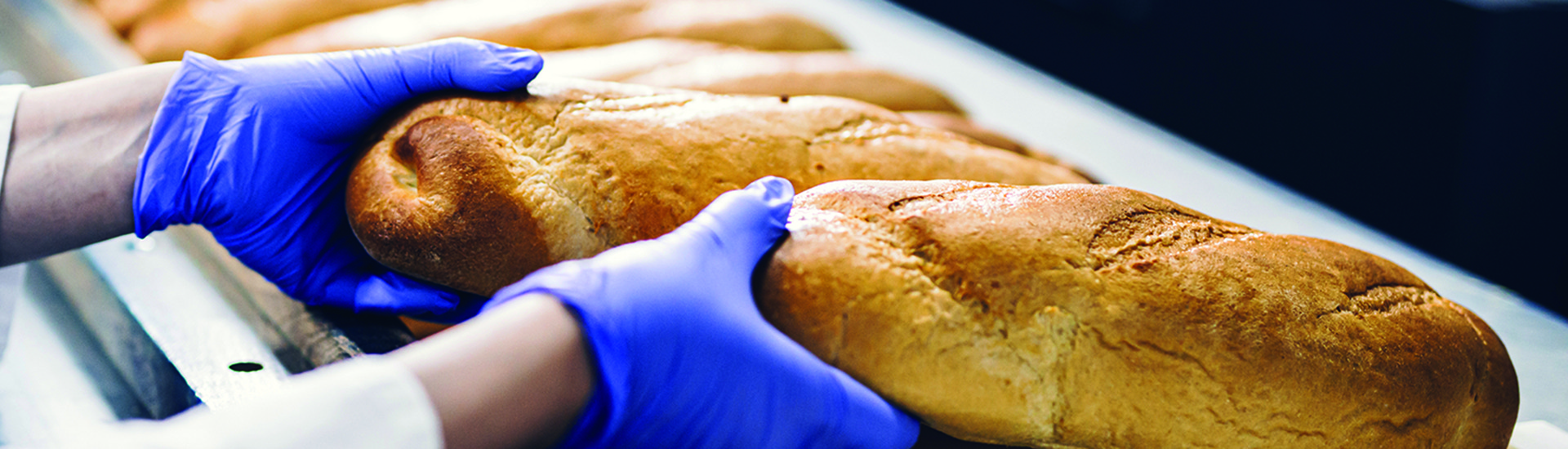 baker woman working at bread production line.