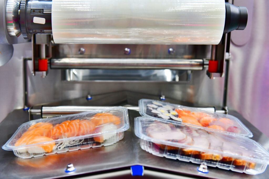 sushi in boxes transfer on automated conveyor systems for package.