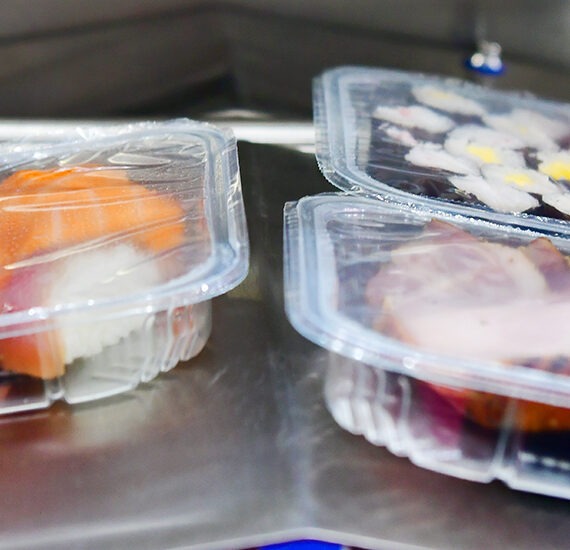 sushi in boxes transfer on automated conveyor systems for package.