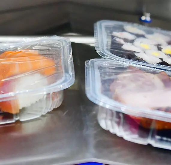 sushi in boxes transfer on automated conveyor systems for package.