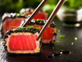 fried tuna steak in black sesame with chopsticks