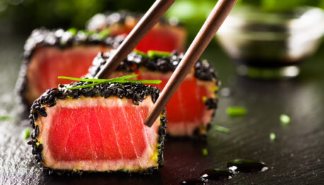 fried tuna steak in black sesame with chopsticks