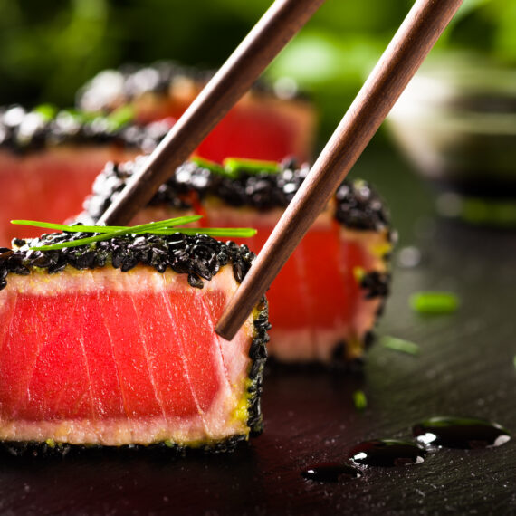 Denrée Prête à Manger (PAM) ou non-PAM fried tuna steak in black sesame with chopsticks